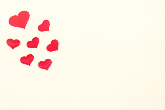 Red hearts on a beige background. Happy valentines day. Copy space
