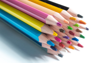 a stack of multi-colored pencils on a white background.