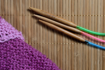 circular knitting needles lie next to the beaches.