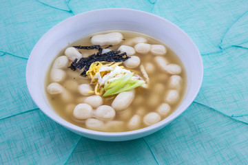 Korean style rice cake soup which is called Jolaeng-i Ddukkuk eats on the Lunar moon new year