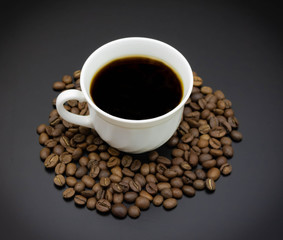 cup of coffee with beans on a dark background