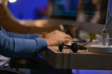 Headset on table of technical support agent at night