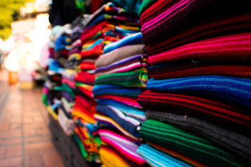 colorful pancho's for sale at the market.