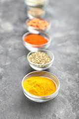 Many different spices on grey background