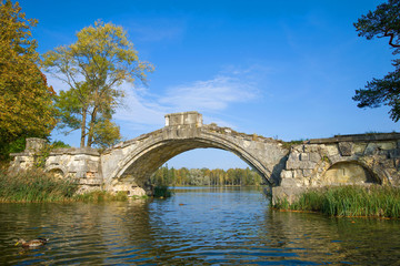 The ruins of the ancient Humpback Bridge close up on a sunny September day. Gatchina, Russia