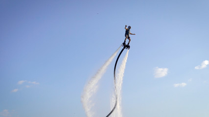 Wild man flying straight up on flyboard