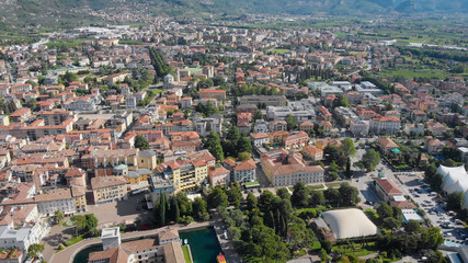 Obraz premium Aerial shot. Top view of the beautiful Italian city of Riva Del Garda. Old low houses, narrow streets and the beautiful Lake Garda.