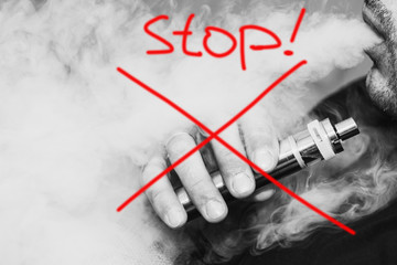 Ban electronic cigarettes. A man holding an electronic cigarette. Harm to health, replacement of...