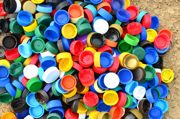 Plastic bottle caps background. Cap material is recyclable.Remove lids from plastic bottles before recycling them. Recycling collection and processing plastic bottle caps