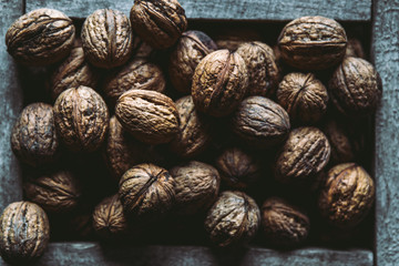 Walnuts with and without shells (filling the picture). Background of fresh walnuts.