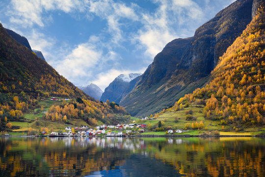 The village of Undredal is a small village on the fjord. Aurlandsfjord West coast of Norway, High mountains and villages reflect in the water during autumn season.