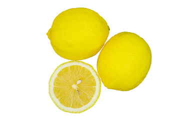 Whole lemons and half a lemon in close-up, isolated on a white background. Natural fruit. Photo taken from above