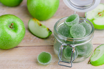 Apple green marmalade candy in sugar in a glass jar. Delicious homemade  jelly sweets. Healthy dessert for gourmets. Selective focus