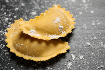Ravioli on grey wooden table, closeup. Italian pasta