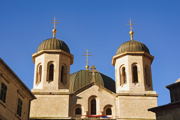 Religious architecture. Montenegro, Old Town of Kotor. Domes of Orthodox Church of St. Nicholas against blue sky