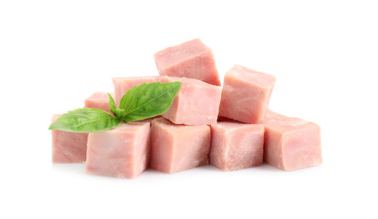 Cubes of tasty fresh ham with basil isolated on white