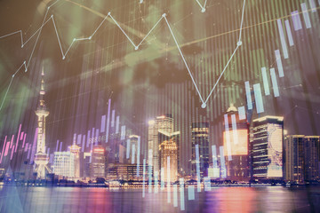 Financial graph on night city scape with tall buildings background double exposure. Analysis concept.