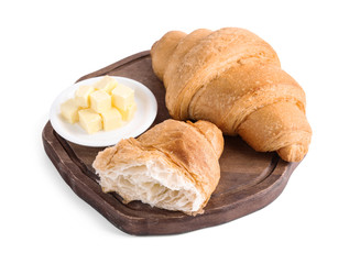 Tasty fresh croissants with butter on white background