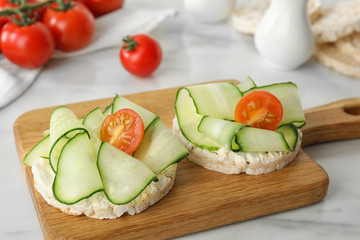 Puffed rice cakes with vegetables on white marble table