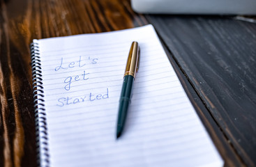 Blogger concept. There is a pc laptop with notebook and pen at a table in a cafe. selective focus