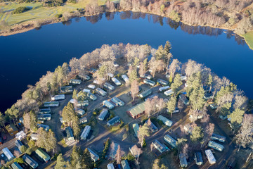 Caravan site park aerial view illuminated by summer sun on Scottish coastal ocean sea island in the...