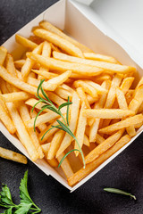 Fast food delivery concept. Fried fries in a white box of eco paper. A glass of lemonade. background image, copy space text