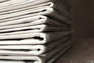 Stack of newspapers on table, closeup. Journalist's work