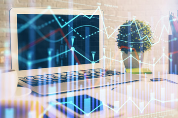Forex market chart hologram and personal computer background. Multi exposure. Concept of investment.