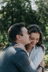 Fototapeta premium Love Couple concept. Quality time together, improve relationship, Physical Touch. Happy young man and woman hug and kiss outdoor