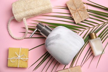 Flat lay composition with marble soap dispenser on pink background