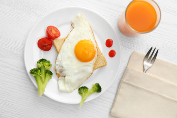 Fototapeta na wymiar Tasty fried eggs with vegetables and juice on white wooden table, flat lay. Delicious morning meal