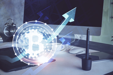 Double exposure of blockchain theme hologram and table with computer background. Concept of bitcoin crypto currency.