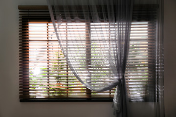 Window with beautiful curtain and blinds, closeup