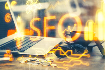 Multi exposure of table with computer and seo drawing hologram. Search optimization concept.