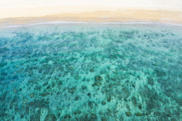 (Selective focus) View from above, stunning aerial view of a white sand beach bathed by a beautiful turquoise sea. Tanjung Aan Beach, east of Kuta Lombok, West Nusa Tenggara, Indonesia.