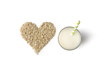 Creative composition with glass, straw and oatmeal isolated on white background