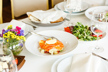 Salmon snacks, soft cheese, and organic vegan salad served in a restaurant. Healthy food, special meal