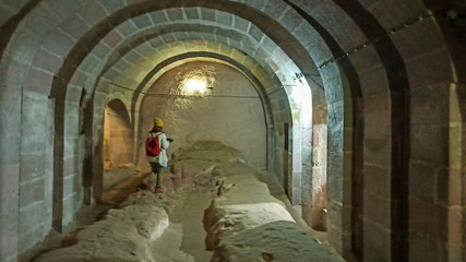 Woman alone in Ancient multi-level cave Derinkuyu Underground City in Cappadocia, Turkey