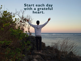Inspirational motivational quote - Start each day with a grateful heart. With blurry background of...