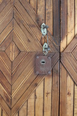 wooden door with old metal lock and rusty handle in the house