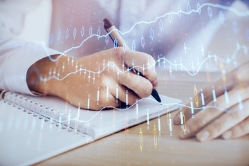 Multi exposure of man planing investment with stock market forex chart.