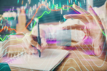 Forex chart displayed on woman's hand taking notes background. Concept of research. Multi exposure