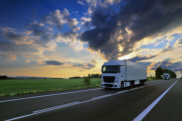 White truck transport on the road at sunset and cargo