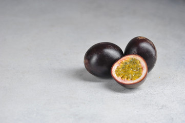 Passion fruit is the fruit of tropical vines. Close-up. Light background. Free space for text. 