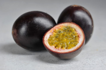 Passion fruit is the fruit of tropical vines. Passion fruit takes up the whole frame. Macro shot. Light background.