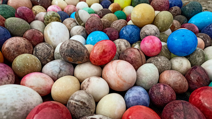 Fototapeta na wymiar Lots of colorful and bright Easter Eggs made by marble stone in Anatolia, Turkey