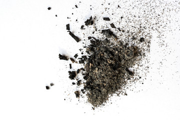 Randomly scattered pile of ash on a light background. Selective focus. - obrazy, fototapety, plakaty