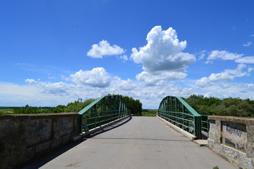 Fototapeta na wymiar Beautiful clouds over the plain Bridge to Lukino Selo