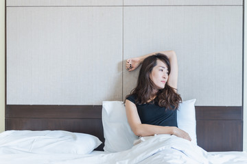 depress woman sitting on bed in room, sadness and depress concept