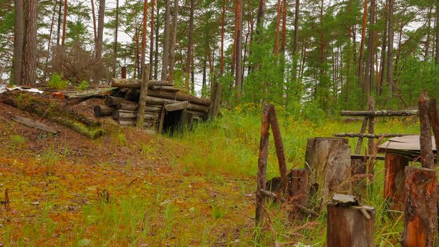 Abandoned hut and equipment of poachers in the forest of Karelia (Russia). Gloomy rainy autumn day.
